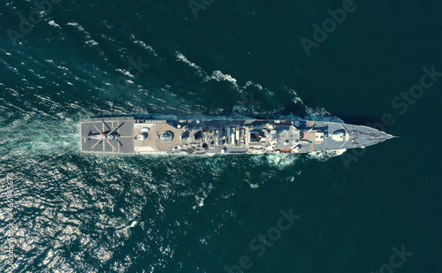 Aerial view of naval ship, battle ship, warship, Military ship resilient and armed with weapon systems, though armament on troop transports. support navy ship. Military sea transport. © alzay