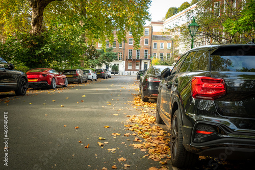 Attractive residential street with parked cars in Kensington, London 