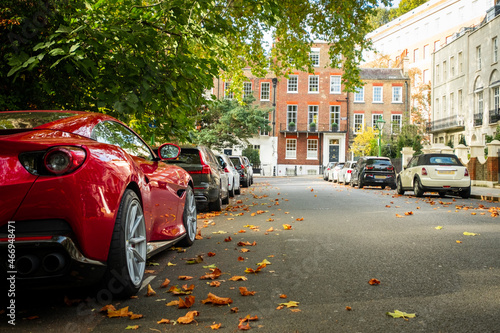 Photography Attractive residential street with parked cars in Kensington, London