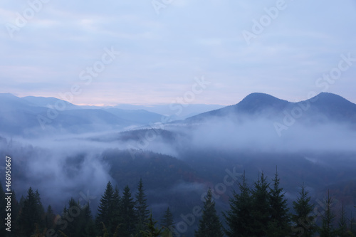Beautiful view of mountains covered with fog during sunrise