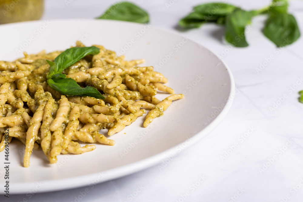 Trofie with pesto, Italian pasta with basil sauce. Pasta with pesto on a white background