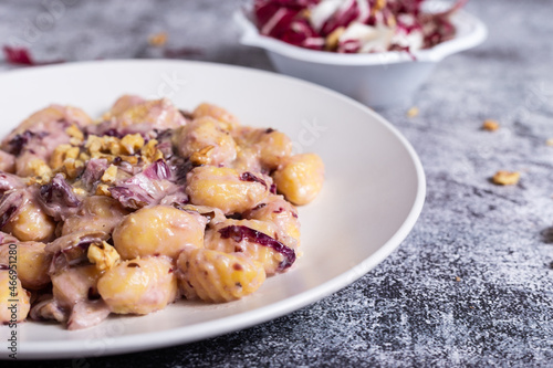 Vegan potato gnocchi with walnut and radicchio sauce photo