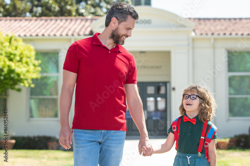 Father supports and motivates son. Kid going to primary school. Back to school and happy time. © Volodymyr