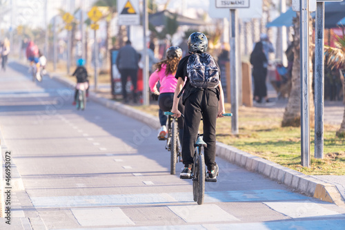 Fototapeta Naklejka Na Ścianę i Meble -  young people riding a bicycle on a bikeway in La Serena