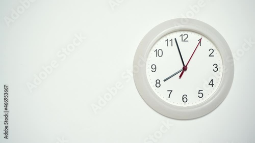 White wall clock ticking showing eight hours. 8 o'clock. Time deadline concept. Timelapse.