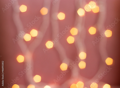 yellow defocused lights garland on pink background