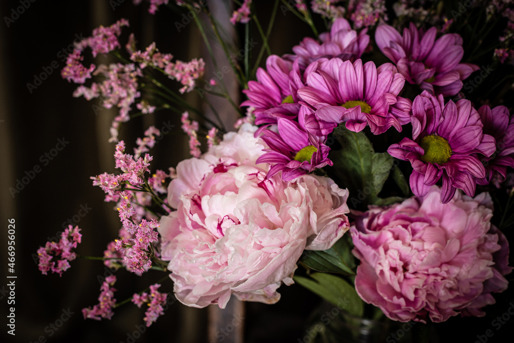 Bouquet of flowers on shabby chair