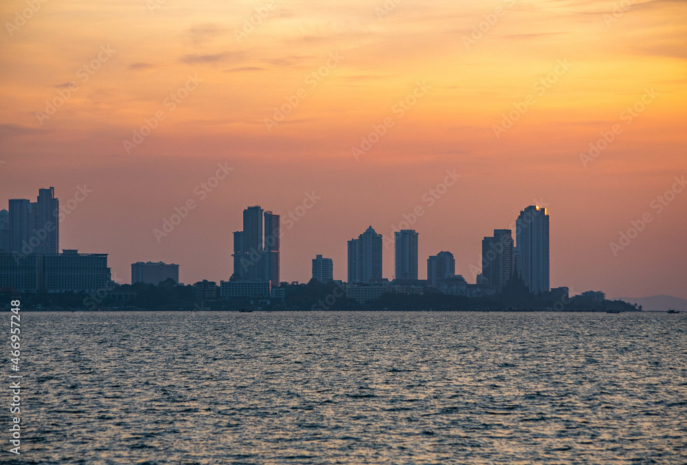 Pattaya city viewed from the middle of the sea during the sunset