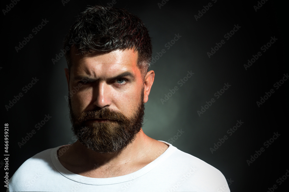 Stylish bearded man. Serious man with beard and mustache. Sexy look of male model. Cool bearded man in white t-shirt with short hair. Natural confident portrait concept. Advertise barbershop concept.