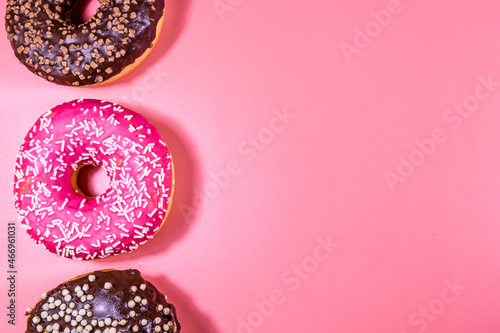 Fresh glazed donuts isolated on a pink background