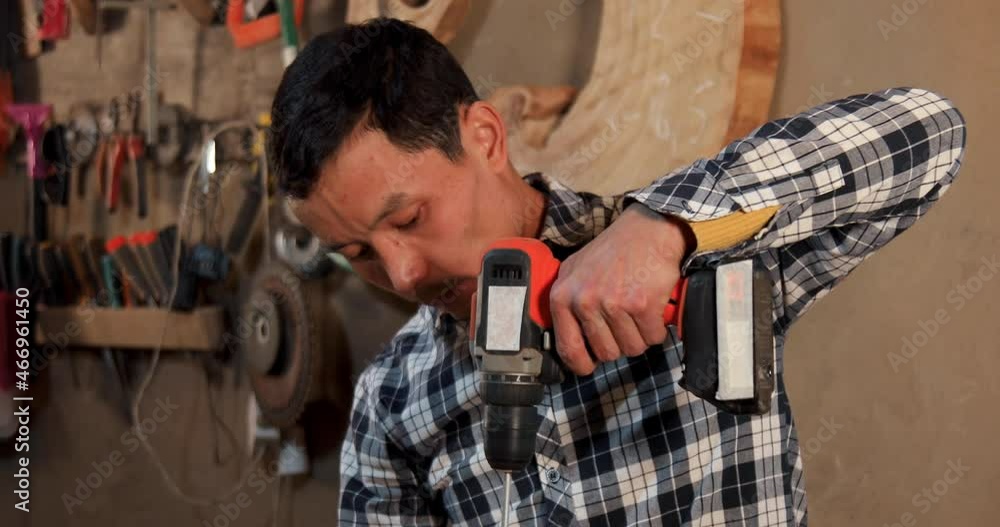 Close up of carpenter using an electric mixer Close up of carpenter using an electric mixer