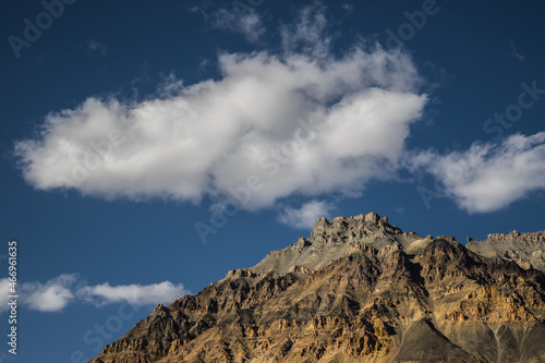 Beautiful Himalayan mountains above the green fields of the village of losar in the Spiti valley, Himachal Pradesh. Losar is a tiny village located at extreme end in cold desert valley of Spiti.