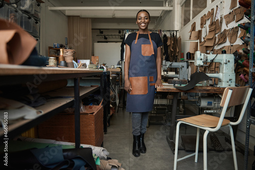 Young African female leather worker standing in her artisanal studio