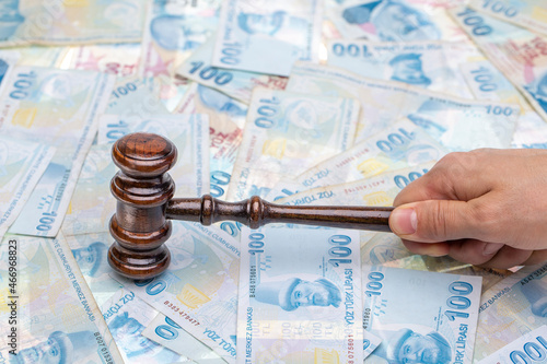 Court gavel on money background. Turkish lira money and judges gavel on table. Judgement and bribe. corruption photo