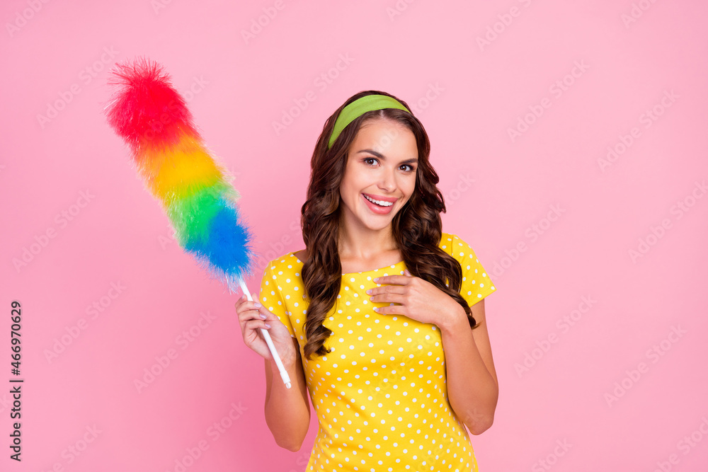 Photo of charming impressed young woman wear yellow dress smiling cleaning dust isolated pink color background Photo of charming impressed young woman wear yellow dress smiling cleaning dust isolated pink color background