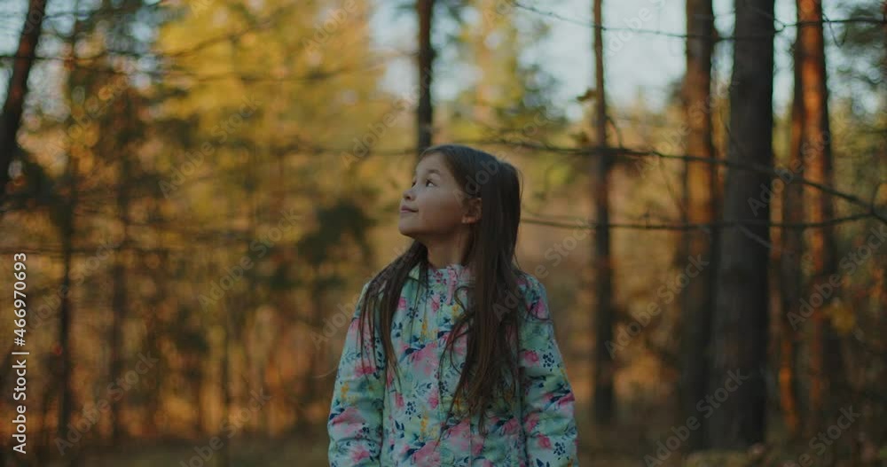 The girl laughs sincerely and rejoices at the autumn leaves in the forest. The girl laughs sincerely and rejoices at the autumn leaves in the forest.