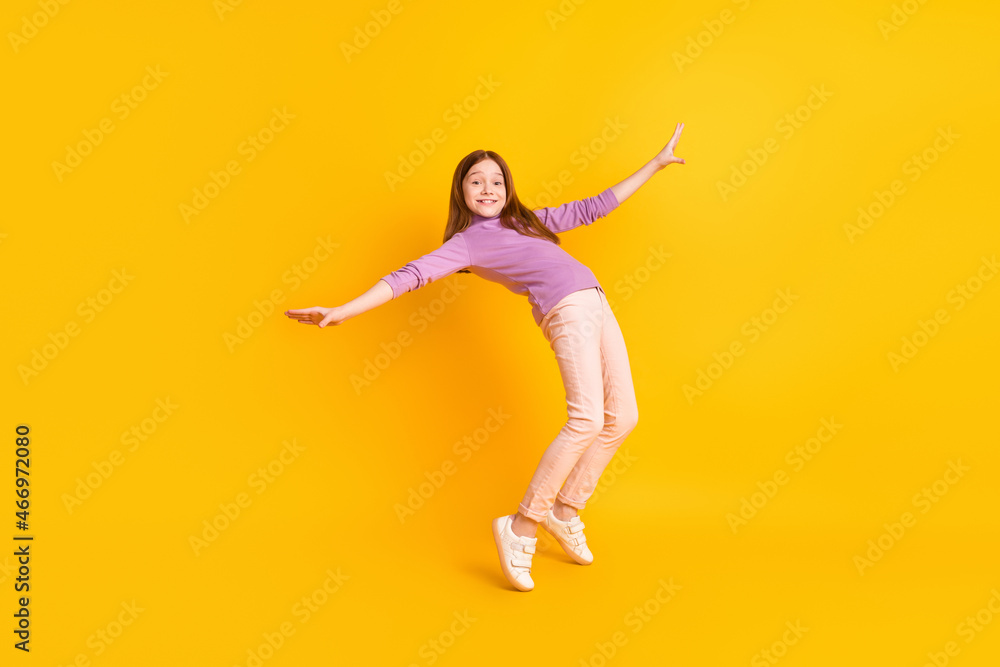 Full size photo of happy excited positive smiling funky beautiful girl dancing fooling isolated on yellow color background Full size photo of happy excited positive smiling funky beautiful girl dancing fooling isolated on yellow color background