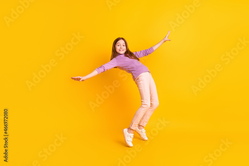 Full size photo of happy excited positive smiling funky beautiful girl dancing fooling isolated on yellow color background