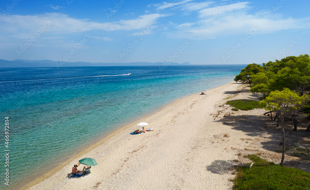 Beach with few people on  Kassandra peninsula. Chalkidiki, Aegean sea, Greece