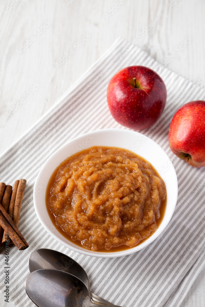 Homemade Raw Apple Sauce in a White Bowl, side view. Homemade Raw Apple Sauce in a White Bowl, side view.