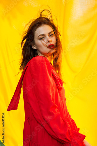 pretty woman in red dress nature yellow cloth on background © VICHIZH