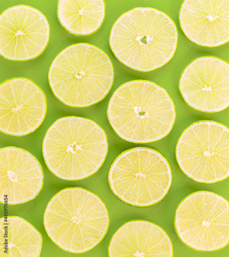 Sliced limes against a green background