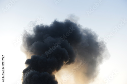 Thick dark smoke over a fire