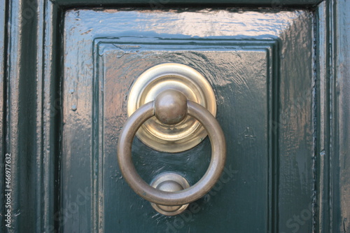 Vintage brass door knocker on an old door, Italy, Rome