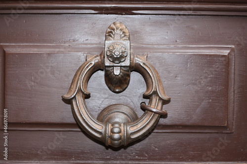 Vintage brass door knocker on an old door, Italy, Rome