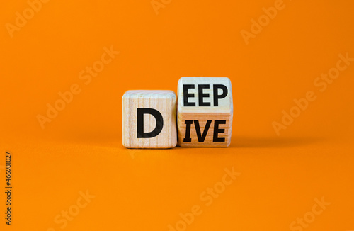 Deep dive symbol. Turned a wooden cube with words 'Deep dive'. Beautiful orange table, orange background. Deep dive and business concept. Copy space. photo