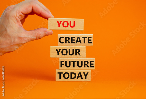 You create your future today symbol. Wooden blocks, words 'You create your future today'. Businessman hand. Beautiful orange background, copy space. Business, motivational and create future concept.