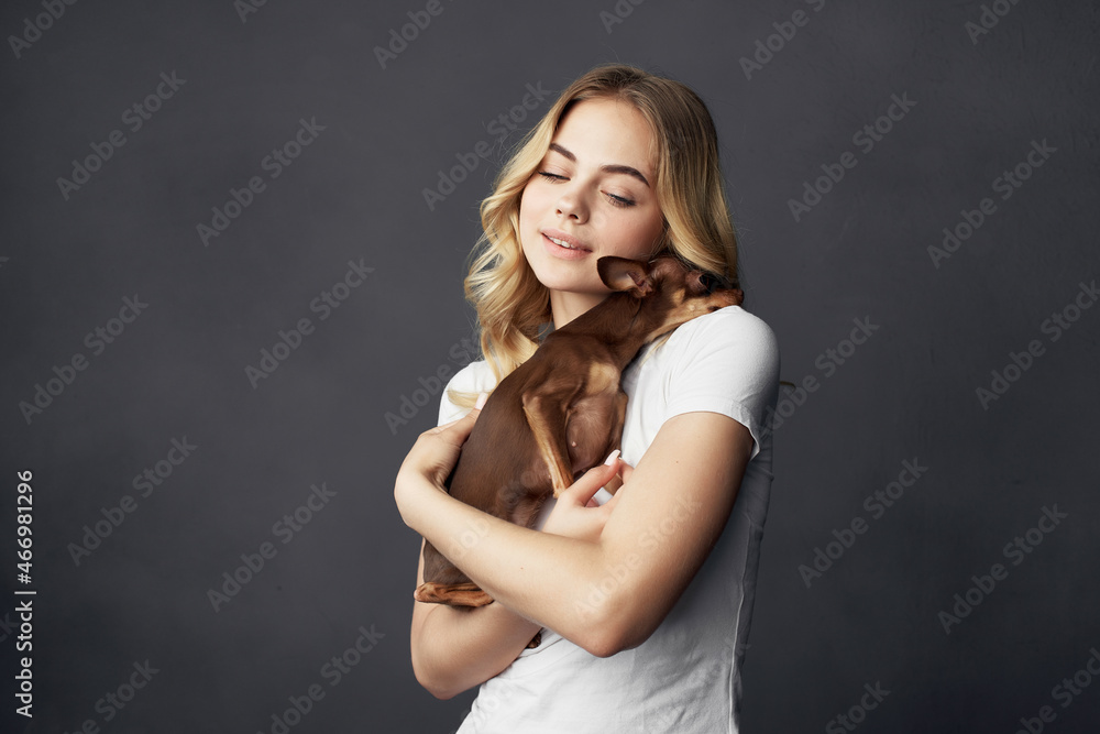 Fototapeta premium pretty woman with a small dog makeup posing dark background