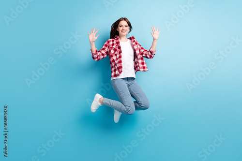 Full body photo of cheerful young happy positive woman jump up air weekend isolated on blue color background