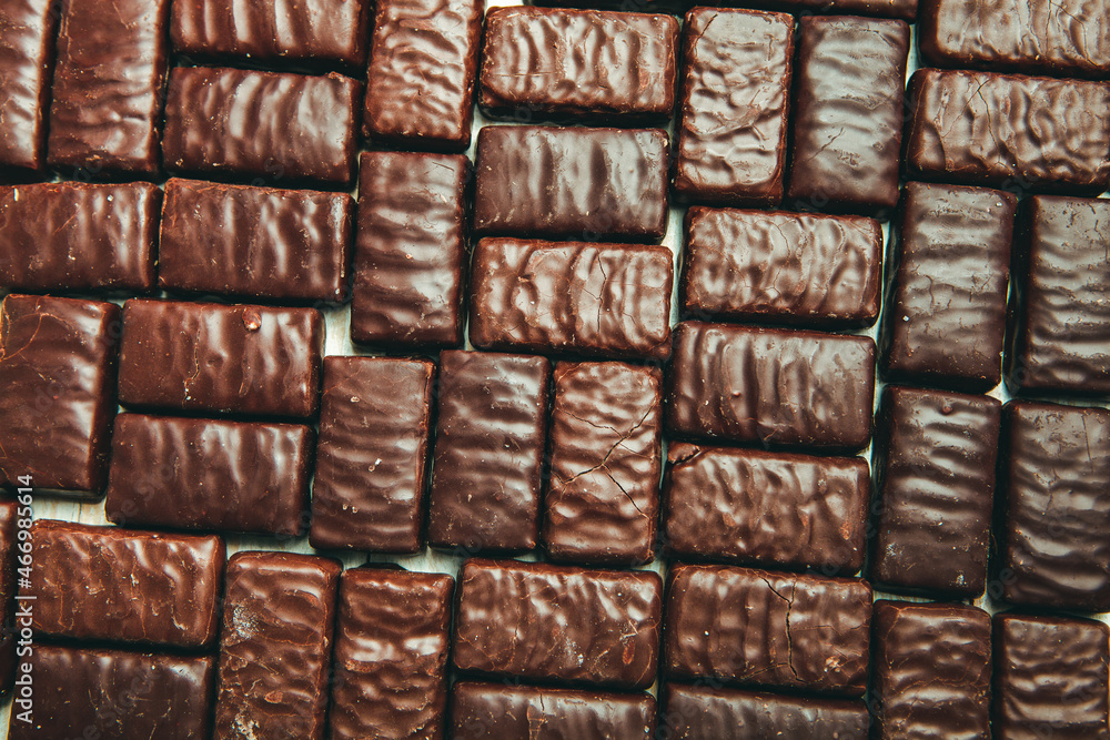 Obraz premium Assorted chocolate candies on wooden background. Chocolate sweets. Dessert background.