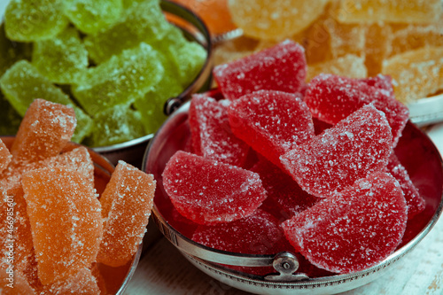 Dessert marmalade in the form of lemon and orange slices. The sweetness of jelly candy. photo