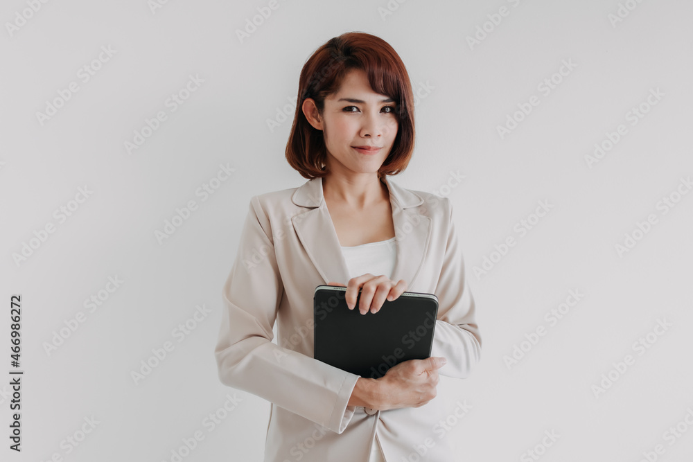 Confident Asian business woman hold a tablet isolated on white background. Confident Asian business woman hold a tablet isolated on white background.