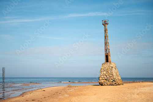abandoned ruins of Kurmrags Lighthouse on the shore of the Rigas Gulf, Baltic sea, Latvia