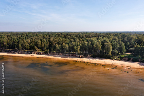 Fototapeta Naklejka Na Ścianę i Meble -  aerial sea side view of the Baltic Sea coast with a sandy beach and red sandstone cliffs
