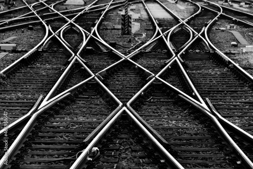Fotobehang Railway tracks with switches and interchanges at a main line station in Frankfurt Main Germany with geometrical structures, thresholds, gravel and screws