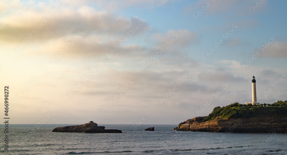 coucher de soleil sur une île et son phare