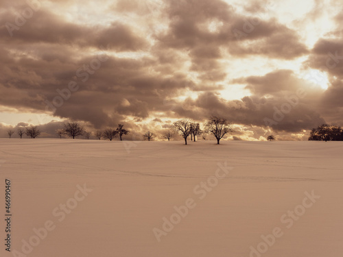 Magnificent snow-capped landscapes, hill and meadow under cloudy sky in the valley of Wiesental and lake Eichen in Southern Black Forest in Germany