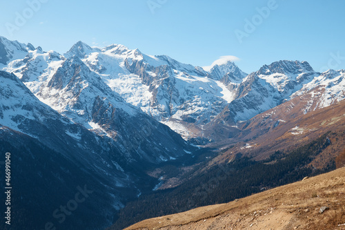 Dombay, alps, snow-covered slopes, the first snow in the mountains, sun and good weather, winter ski season