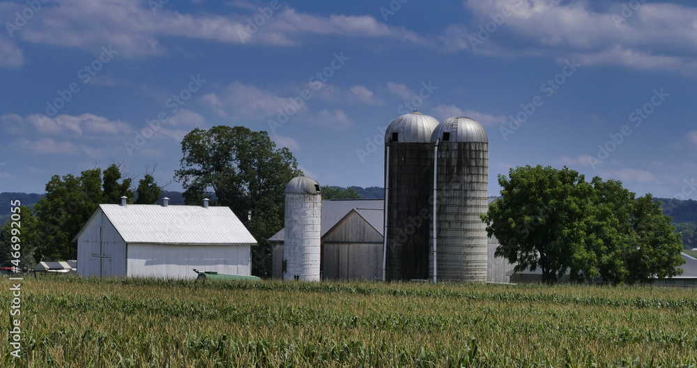 An Amish Barn and Silo in the Countryside as Seen on a Beautiful Sunny Day