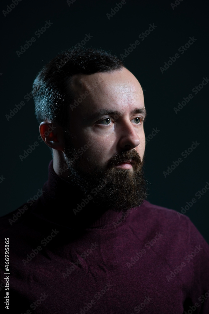portrait of a bearded millennial guy in a burgundy sweater on a gray background portrait of a bearded millennial guy in a burgundy sweater on a gray background