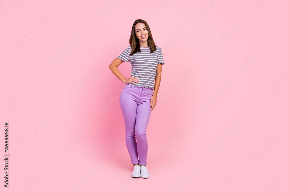 Photo of charming sweet young lady wear striped outfit smiling standing arm waist isolated pink color background Photo of charming sweet young lady wear striped outfit smiling standing arm waist isolated pink color background
