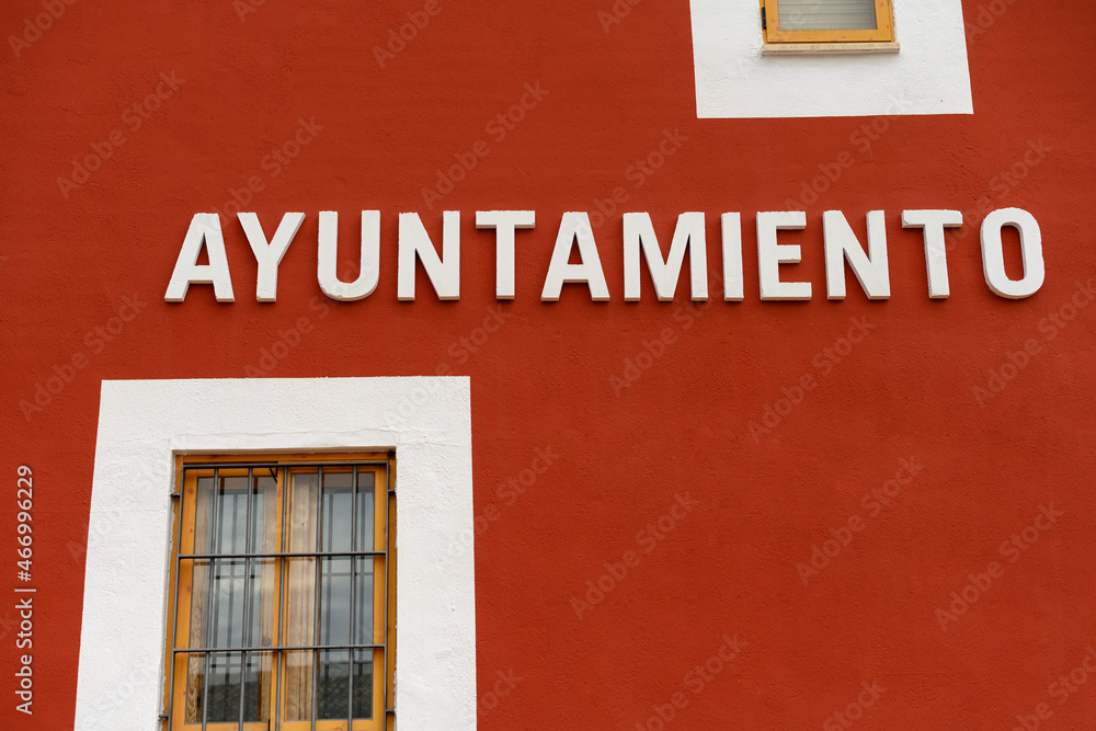 Front of official building with letters in Spanish: City Hall Front of official building with letters in Spanish: City Hall
