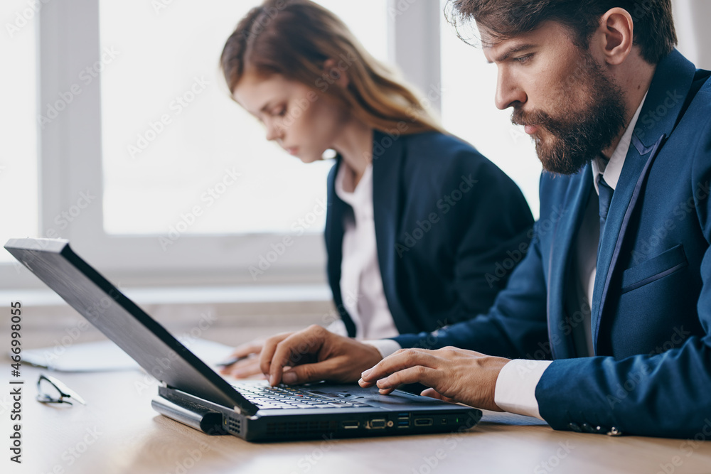 managers sitting in front of a laptop teamwork officials managers sitting in front of a laptop teamwork officials