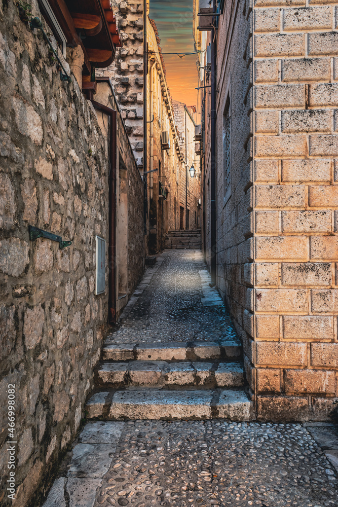 Narrow alley in the old town at night. Dubrovnik, Croatia.