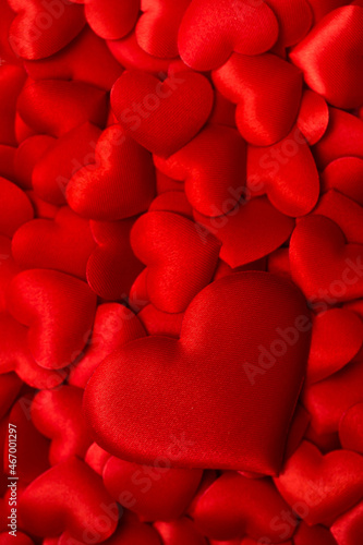 Background from hearts. Red hearts on a red background top view. Background for love flat lay.