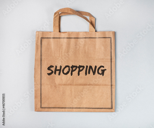 Shopping word on craft paper bag, empty package.